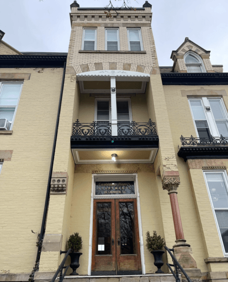 a building with a door and a light on the side of it